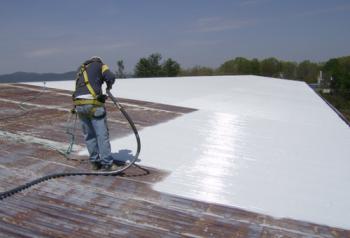 man applying white pu liquid for waterproofing of roofs